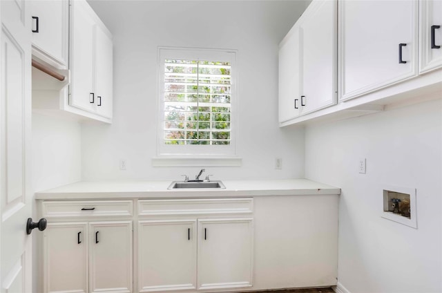 washroom featuring washer hookup, a sink, and cabinet space