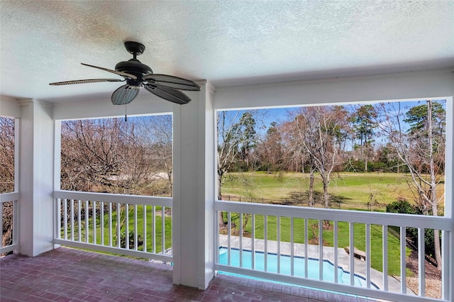 exterior space featuring ceiling fan