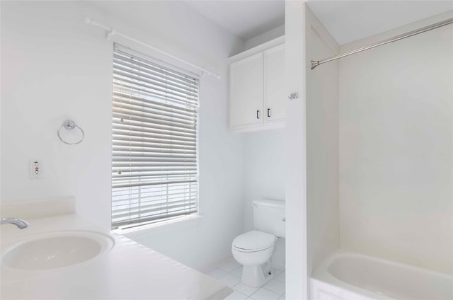 full bath featuring a sink, toilet, and tile patterned floors