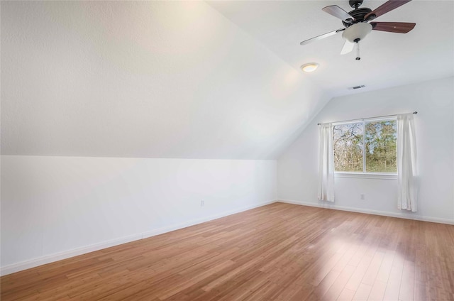 bonus room featuring visible vents, baseboards, lofted ceiling, ceiling fan, and wood finished floors