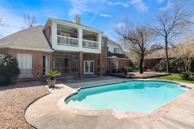 pool with ceiling fan, a patio, and french doors