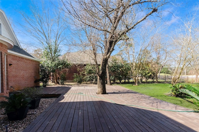 deck with fence and a lawn