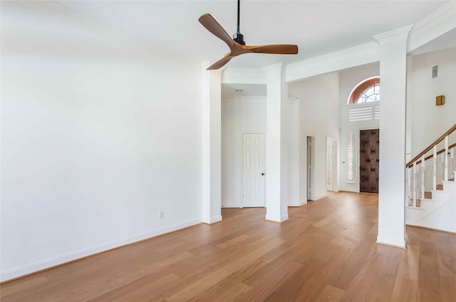 entryway featuring stairs, ornamental molding, light wood-style flooring, and baseboards