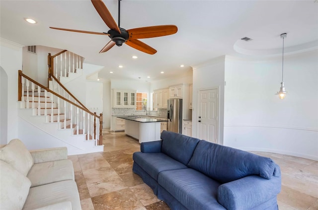 living area featuring visible vents, ceiling fan, ornamental molding, stairs, and recessed lighting