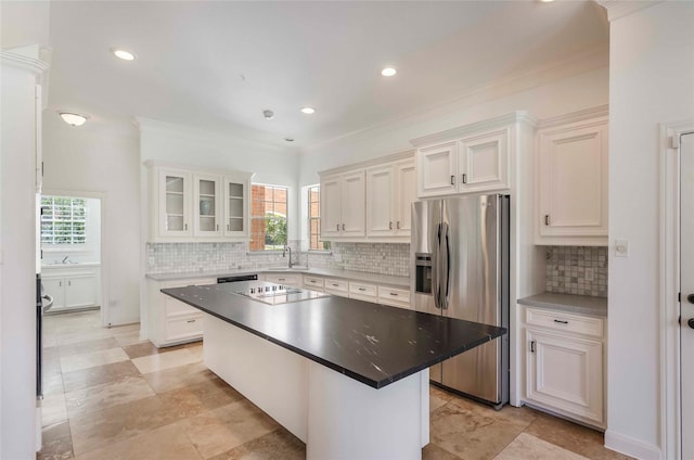 kitchen with white cabinets, black electric stovetop, stainless steel refrigerator with ice dispenser, and a sink