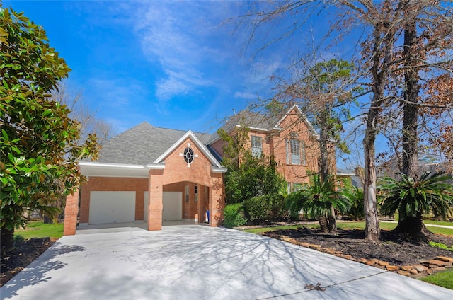 view of front of house with a garage, brick siding, driveway, and roof with shingles