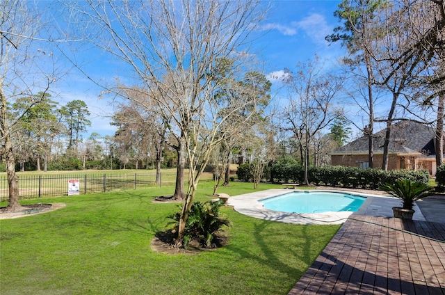 view of pool featuring a lawn, fence, and a fenced in pool