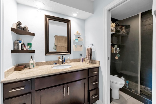 full bathroom with vanity, a shower stall, and toilet