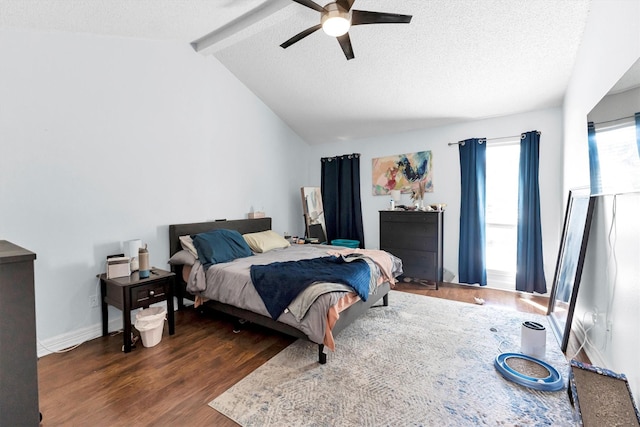 bedroom with vaulted ceiling with beams, a ceiling fan, a textured ceiling, wood finished floors, and baseboards