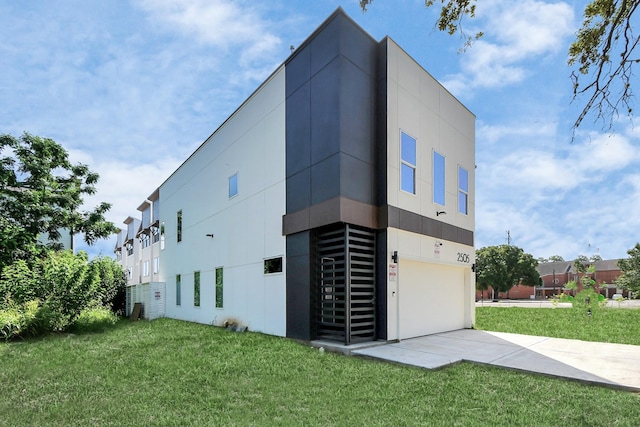 view of home's exterior with driveway, stucco siding, a garage, and a yard