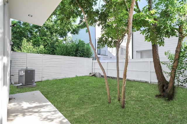 view of yard featuring central AC unit and a fenced backyard