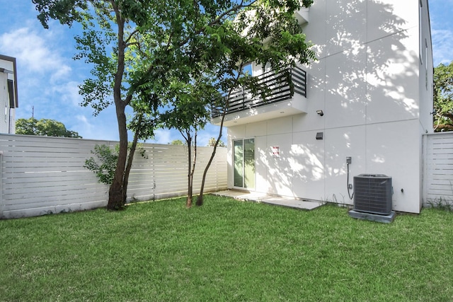 view of yard featuring central AC and a fenced backyard