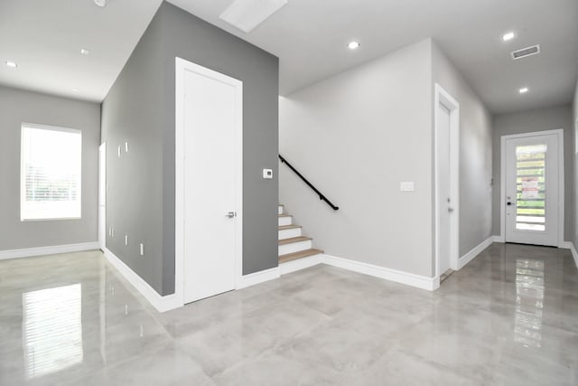 entryway with baseboards, visible vents, stairway, finished concrete floors, and recessed lighting