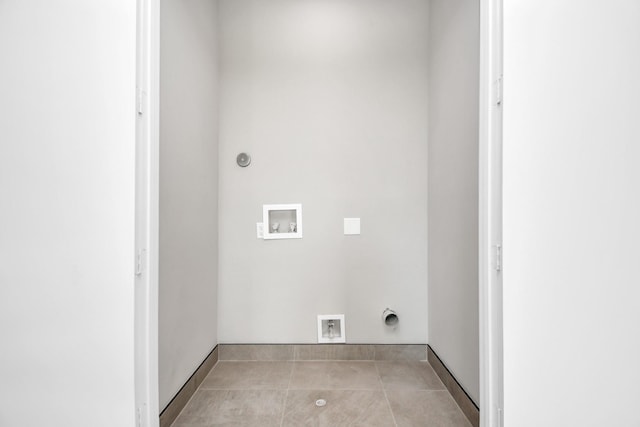 washroom featuring light tile patterned flooring, hookup for a washing machine, and electric dryer hookup