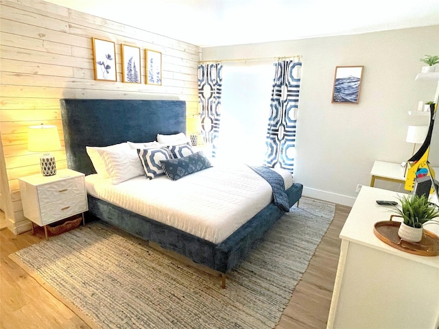 bedroom featuring baseboards and wood finished floors