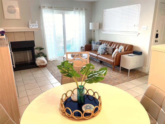 living area featuring light tile patterned flooring and a tile fireplace