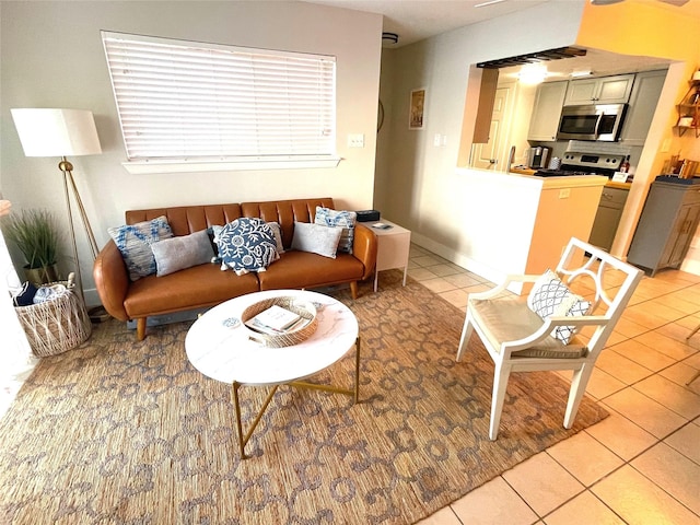 living room with light tile patterned floors and baseboards