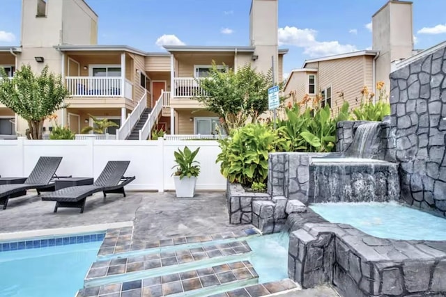 exterior space with a patio, a hot tub, and fence