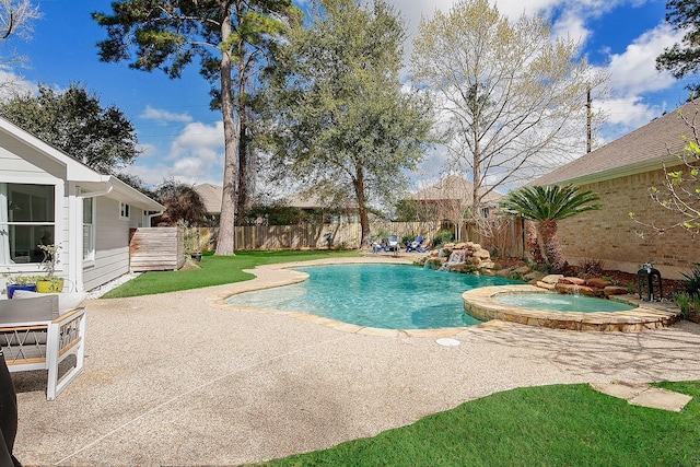 view of pool featuring a patio, a fenced backyard, and a pool with connected hot tub