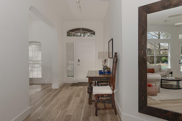 entrance foyer featuring wood finished floors and baseboards