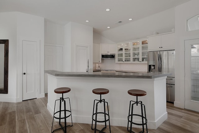 kitchen featuring white cabinetry, wood finished floors, visible vents, and appliances with stainless steel finishes