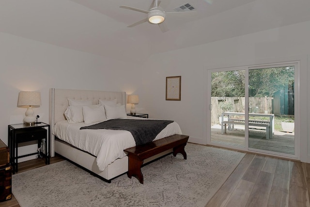 bedroom featuring visible vents, ceiling fan, vaulted ceiling, wood finished floors, and access to outside