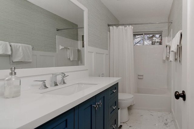 full bathroom with a wainscoted wall, toilet, shower / bath combo with shower curtain, a decorative wall, and vanity