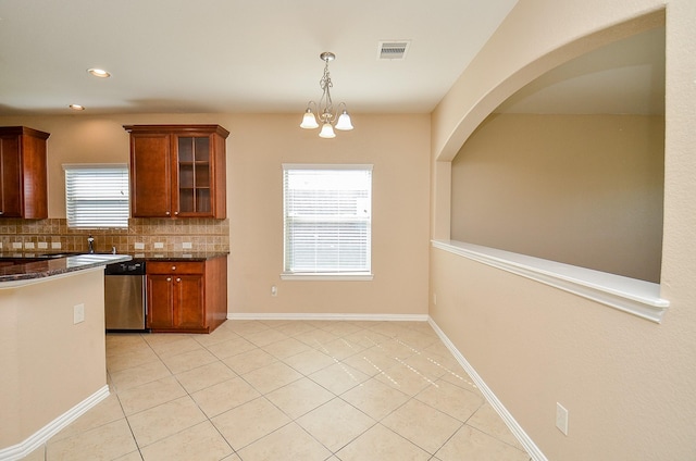 kitchen with light tile patterned floors, visible vents, stainless steel dishwasher, backsplash, and glass insert cabinets