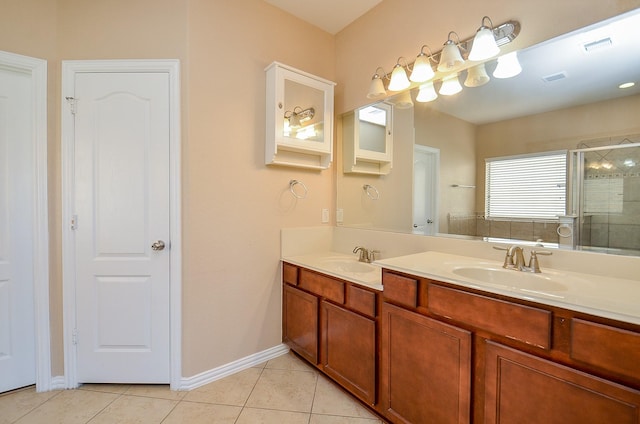 bathroom with tile patterned flooring, a sink, a shower stall, and double vanity