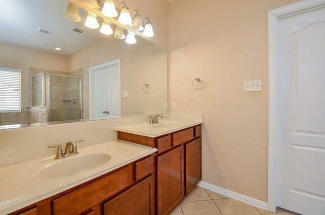 bathroom with vanity, a shower stall, visible vents, and tile patterned floors