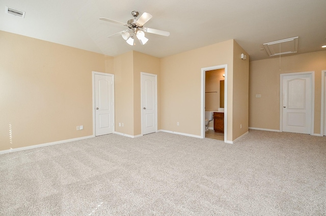 unfurnished bedroom with light carpet, attic access, visible vents, and baseboards