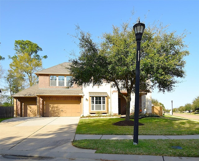 view of front of house featuring a garage, driveway, a front yard, and fence