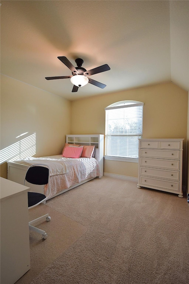 unfurnished bedroom with carpet floors, vaulted ceiling, baseboards, and a ceiling fan