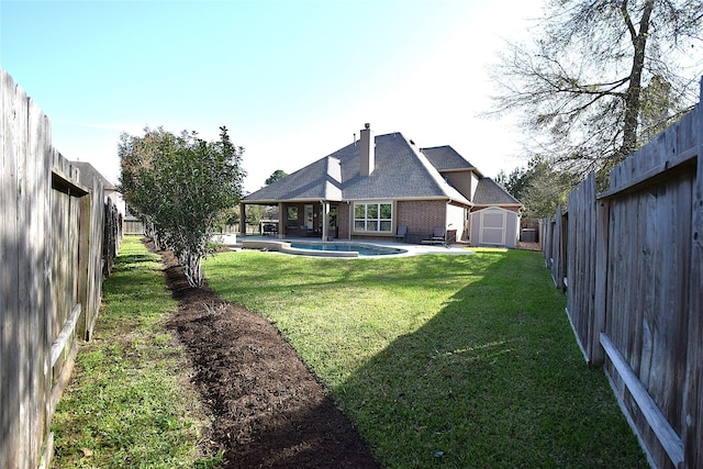 10010 Friesian Estates Dr, Spring, TX 77379 - back of house featuring a storage shed, an outdoor structure, brick siding, a patio area, and a chimney