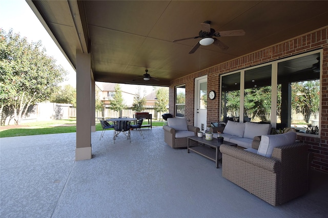 view of patio featuring outdoor dining area, ceiling fan, fence, and an outdoor living space