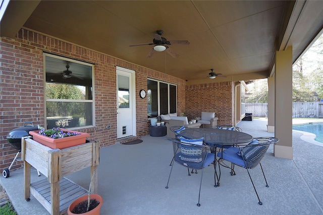 view of patio with a fenced in pool, outdoor dining area, area for grilling, a ceiling fan, and fence