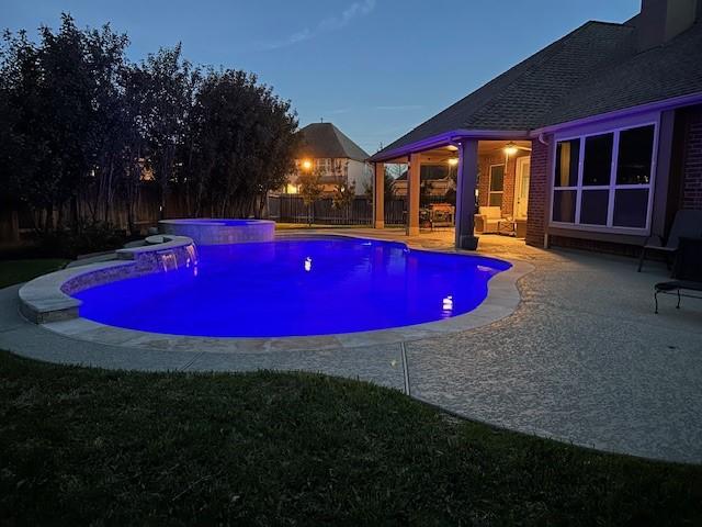 view of swimming pool featuring a fenced in pool, a fenced backyard, a patio, and an in ground hot tub