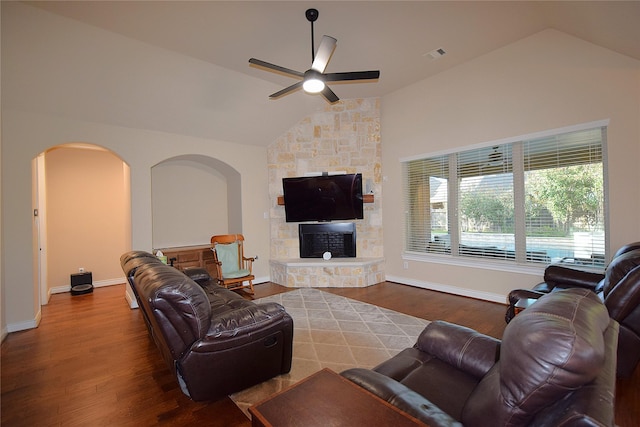 10010 Friesian Estates Dr, Spring, TX 77379 - living area with arched walkways, vaulted ceiling, a ceiling fan, wood finished floors, and a fireplace