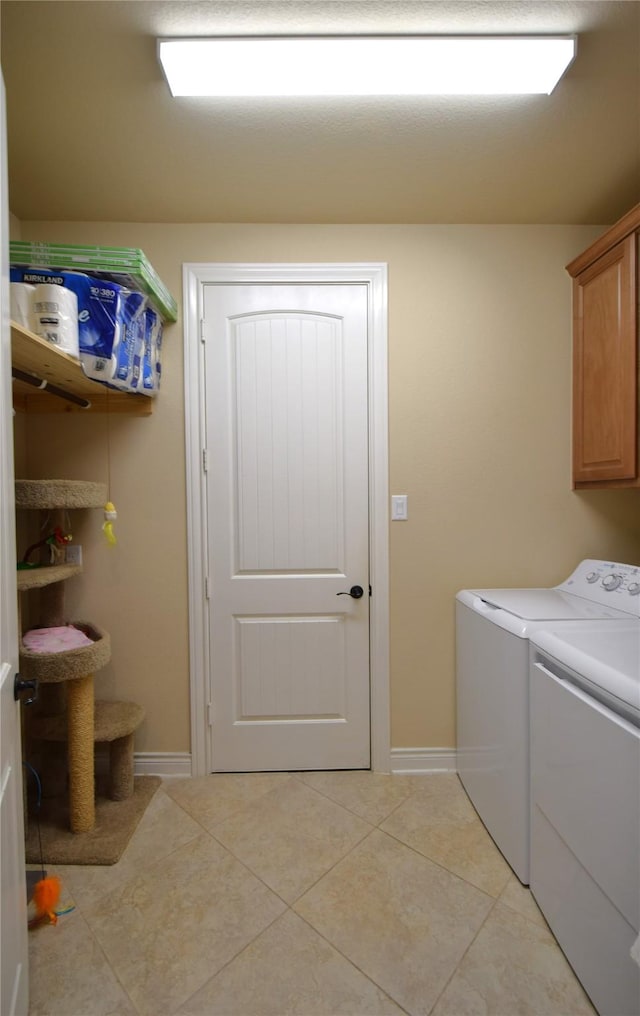 10010 Friesian Estates Dr, Spring, TX 77379 - clothes washing area featuring cabinet space, independent washer and dryer, light tile patterned flooring, and baseboards