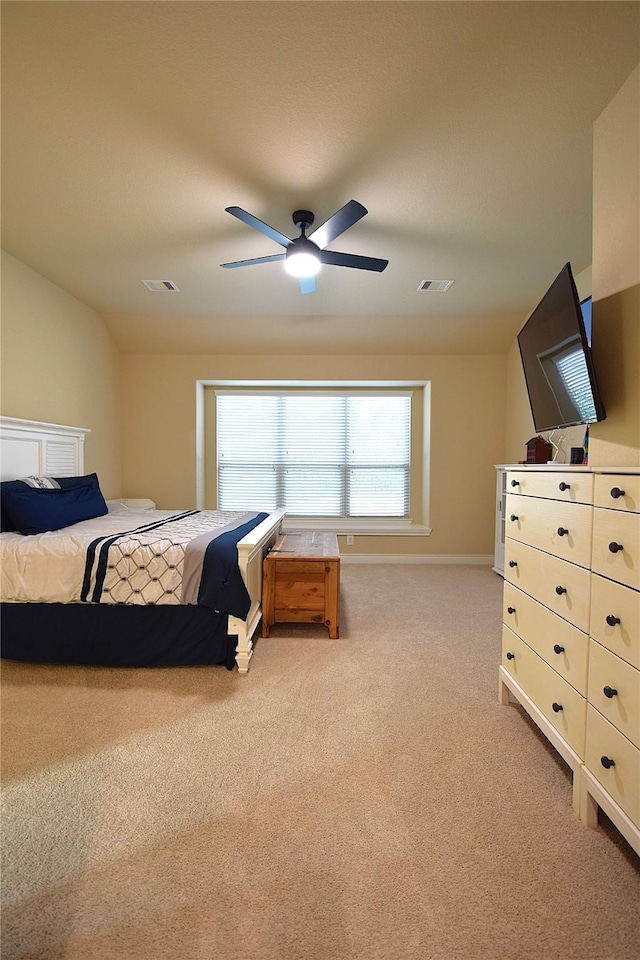 carpeted bedroom with lofted ceiling, ceiling fan, and visible vents