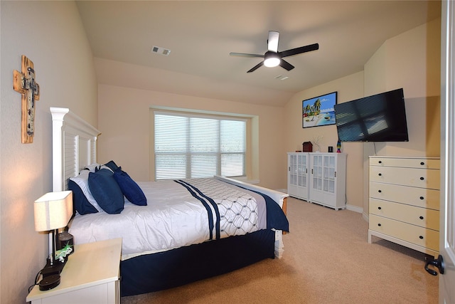 bedroom with light colored carpet, visible vents, a ceiling fan, vaulted ceiling, and baseboards