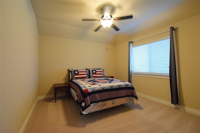 bedroom featuring light carpet, ceiling fan, and baseboards