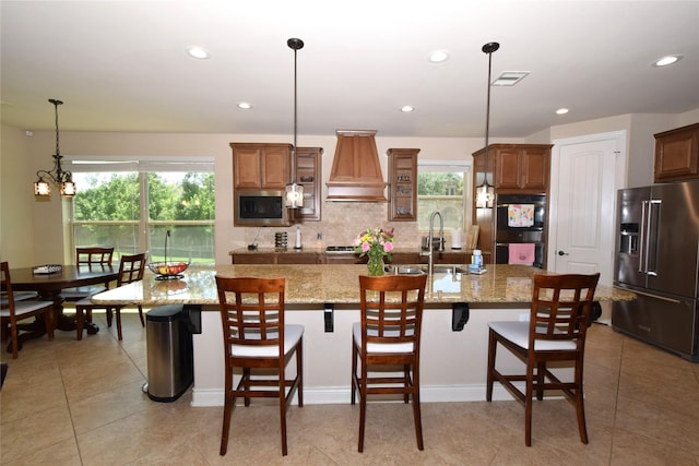 10010 Friesian Estates Dr, Spring, TX 77379 - kitchen featuring appliances with stainless steel finishes, custom exhaust hood, a sink, healthy amount of natural light, and recessed lighting