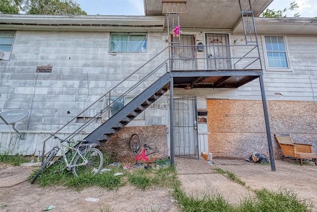 view of exterior entry featuring a balcony