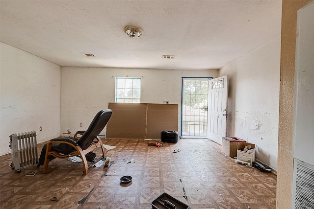 exercise area with visible vents and a textured ceiling