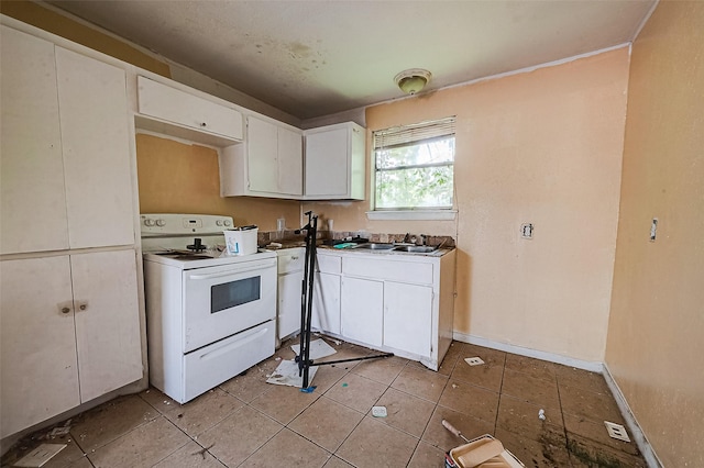 kitchen with light tile patterned floors, a sink, baseboards, white cabinets, and white range with electric cooktop