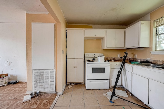 3113 1/2 Anita St Unit A B C, Houston, TX 77004 - kitchen featuring white electric range oven, white cabinetry, and a sink