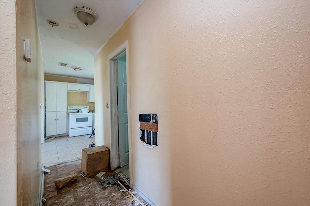 corridor with visible vents and a textured wall