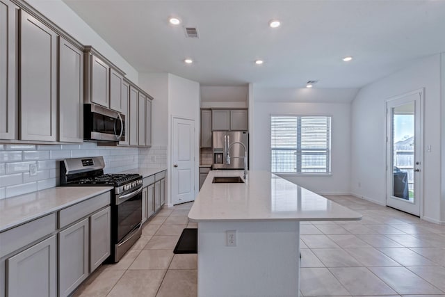 kitchen with light tile patterned floors, visible vents, gray cabinetry, appliances with stainless steel finishes, and a sink