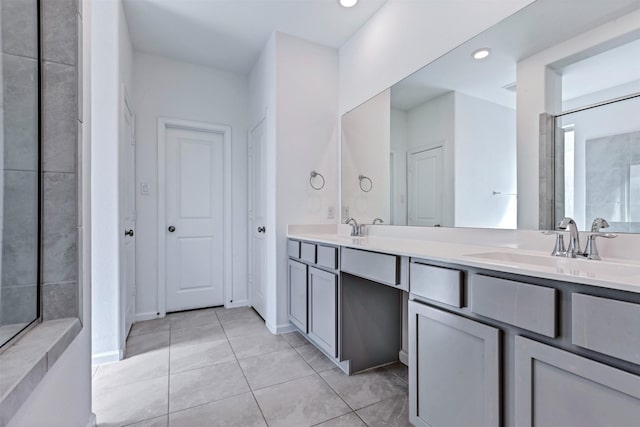 full bath featuring double vanity, recessed lighting, a sink, and tile patterned floors